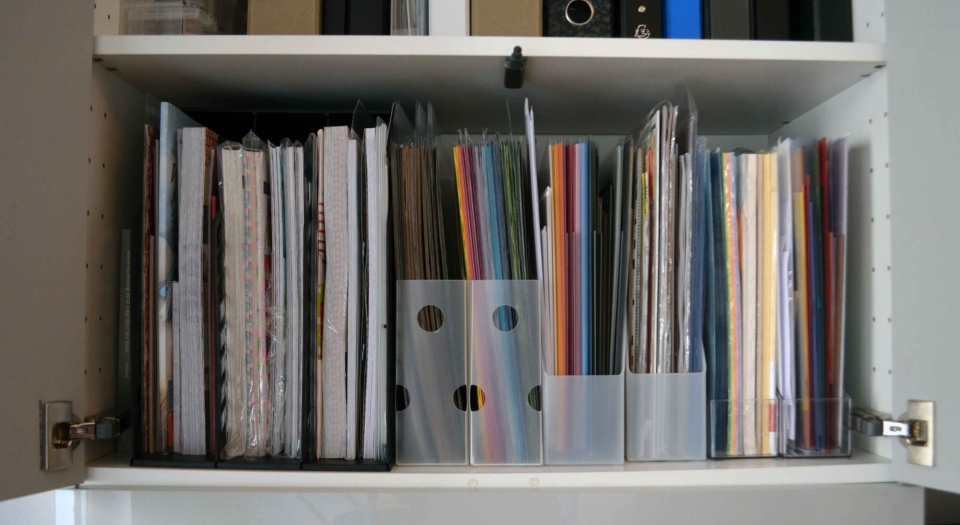 Meine Papiersammlung: Ganz links befindet sich ein breiter Stehsammler für 12"x12"-Papiere, daneben zwei schmale Sammler (ebenfalls für 12"x12"), dann folgen vier handelsübliche Stehsammler für A4-Format.